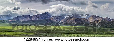Stock Photograph - Panoramic scenic of Polychrome Pass and the Alaska Range, Denali National Park and Preserve, Interior Alaska, summer. Fotosearch