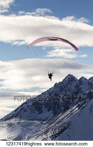 Stock Photograph - Paraglider above the Chugach Mountains, Southcentral Alaska, USA. Fotosearch