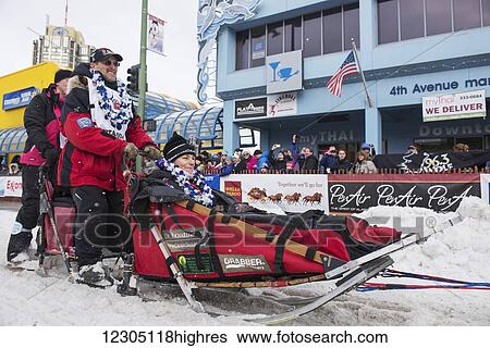 Paul Gebhardt and team leave the ceremonial start line with an Iditarider during the 2016 Iditarod View Large Photo Image Stock Photograph - Paul Gebhardt and team leave the ceremonial start line with an Iditarider during the 2016 Iditarod. Fotosearch