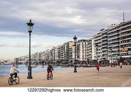 Stock Photograph - Pedestrians and cyclists along the waterfront; Thessaloniki, Greece. Fotosearch