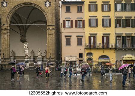 Pedestrians in a town square on a rainy day; Florence, Italy View Large Photo Image Stock Photograph - Pedestrians in a town square on a rainy day; Florence, Italy. Fotosearch