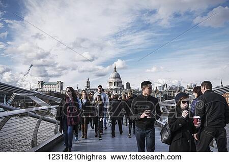 Pedestrians walking across Millennium Bridge with St Paul's Cathedral in the distance; London, England View Large Photo Image Stock Photograph - Pedestrians walking across Millennium Bridge with St Paul's Cathedral in the distance; London, England. Fotosearch