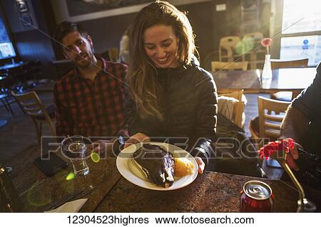 Stock Photograph - People try the local delicacy of Sheep's Head; Reykjavik, Iceland. Fotosearch