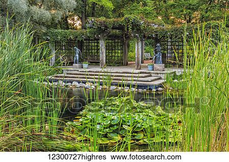 Pergola and lily pond in Leo Mol Sculpture Garden of Assiniboine Park; Winnipeg, Manitoba, Canada View Large Photo Image Stock Photograph - Pergola and lily pond in Leo Mol Sculpture Garden of Assiniboine Park; Winnipeg, Manitoba, Canada. Fotosearch