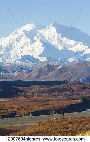 Stock Photograph - Person viewing Denali and Autumn colors from the Eielson Visitor Center. Denali National Park & Preserve. Interior Alaska.. Fotosearch