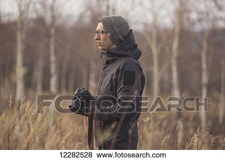 Photographer with a camera and standing in a field, Alaska, Autumn View Large Photo Image Stock Photo - Photographer with a camera and standing in a field, Alaska, Autumn . Fotosearch