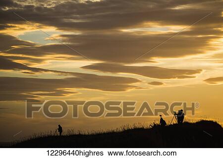 Photographers at dawn photographing the sunrise; Iceland View Large Photo Image Stock Photograph - Photographers at dawn photographing the sunrise; Iceland. Fotosearch