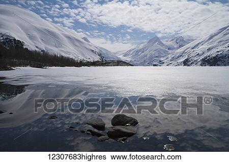 Stock Photograph - Portage Lake during ice breakup in Spring. Southcentral Alaska.. Fotosearch