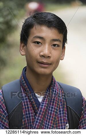 Portrait of a boy with a checkered robe and carrying a backpack; Punakha, Bhutan View Large Photo Image Stock Photograph - Portrait of a boy with a checkered robe and carrying a backpack; Punakha, Bhutan. Fotosearch