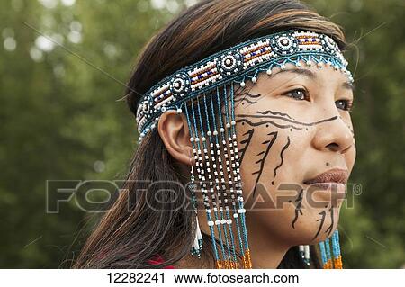 Stock Image - Portrait of a female Alaskan Native with traditional regalia, Alaska. Fotosearch