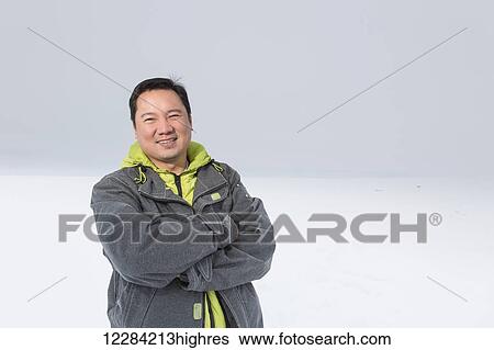 Stock Photograph - Portrait of a man standing on sea ice, Arctic Ocean, Barrow, North Slope, Arctic Alaska, USA, Winter. Fotosearch