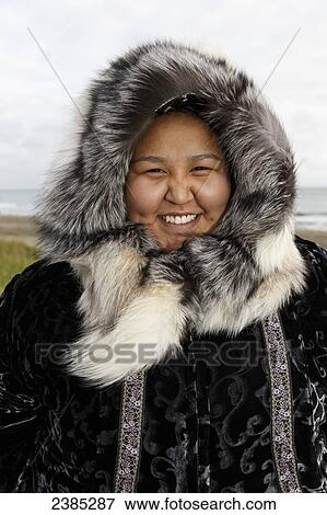 Portrait of Yupik Eskimo girl wearing traditional fur parka and ruff ...
