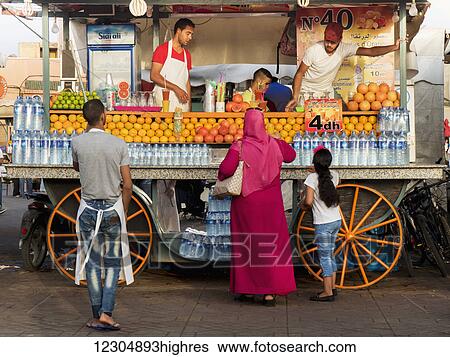 Purchasing a fruit drink from a cart; Marrakech, Morocco View Large Photo Image Stock Photograph - Purchasing a fruit drink from a cart; Marrakech, Morocco. Fotosearch