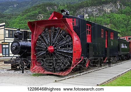 Stock Photograph - Railroad yard, White Pass Railroad steam engine and giagantic snow blower, Skagway, Southeast Alaska. Fotosearch