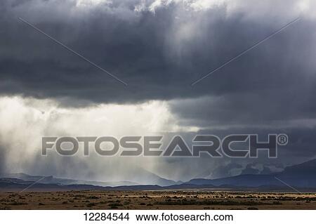 Rain clouds over Seno Ultima Esperanza and Cerro Monumento Morre near Puerto Natales; Magallanes region, Chile View Large Photo Image Picture - Rain clouds over Seno Ultima Esperanza and Cerro Monumento Morre near Puerto Natales; Magallanes region, Chile. Fotosearch