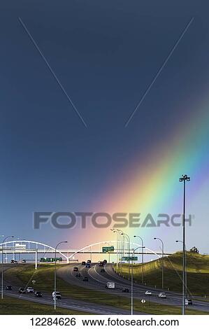 Rainbow over an arched bridge across a highway with stormy sky; Calgary, Alberta, Canada View Large Photo Image Stock Photograph - Rainbow over an arched bridge across a highway with stormy sky; Calgary, Alberta, Canada. Fotosearch
