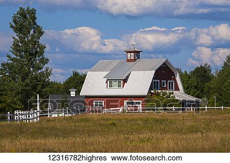 Stock Photograph - Red barn and white fence; Sutton, Quebec, Canada. Fotosearch