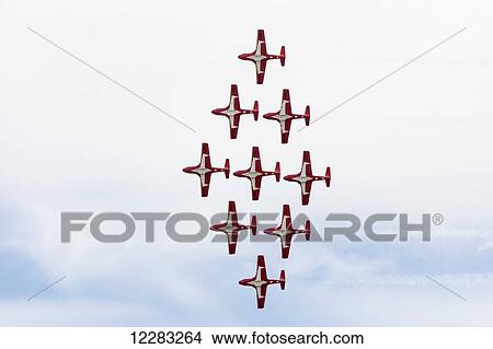 Red demonstration military jet in diamond formation; Lethbridge, Alberta, Canada View Large Photo Image Picture - Red demonstration military jet in diamond formation; Lethbridge, Alberta, Canada. Fotosearch