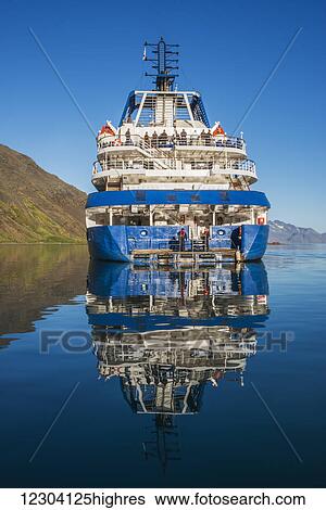 Stock Photograph - Reflection of cruise ship in calm water; Antarctica. Fotosearch