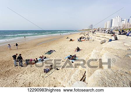 Stock Photograph - Relaxing on a beach along the Mediterranean sea; Joppa, Israel. Fotosearch