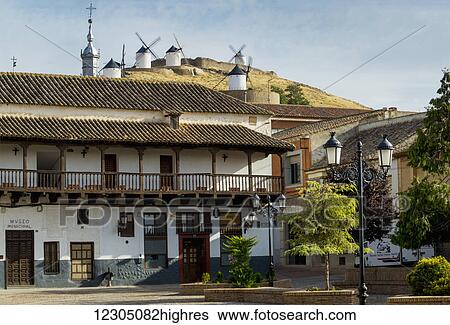 Stock Photograph - Residential buildings with windmills on the hilltop; Consuegra, Castile-La Mancha, Spain. Fotosearch