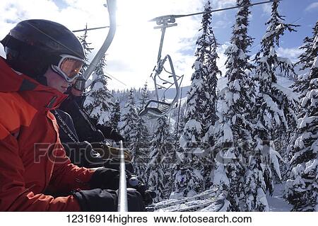 Stock Photograph - Riding up the Harmony Express chairlift; Whistler, British Columbia, Canada. Fotosearch