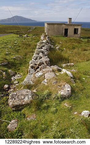 Stock Photograph - Road and lookpost ruin on Achill island on the Wild Atlantic Way coastal route; County Mayo, Ireland. Fotosearch