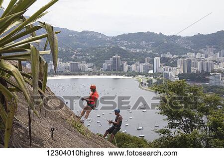 Stock Photograph - Rock climbing up Sugarloaf Mountain, looking to Botafogo Bay; Rio de Janeiro, Brazil. Fotosearch