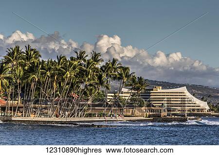 Stock Photograph - Royal Kona Resort on the Kailua-Kona, Hawaii Island waterfront as seen from the Kailua pier; Kailua-Kona, Island of Hawaii, Hawaii, United States of America. Fotosearch