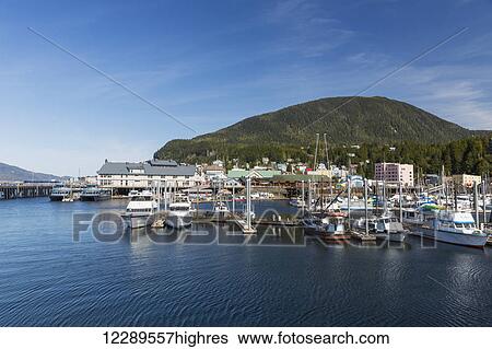 Stock Photograph - Sailboats and fishing boats docked in Ketchikan's harbor along Creek Street, Southeast Alaska, Spring. Fotosearch
