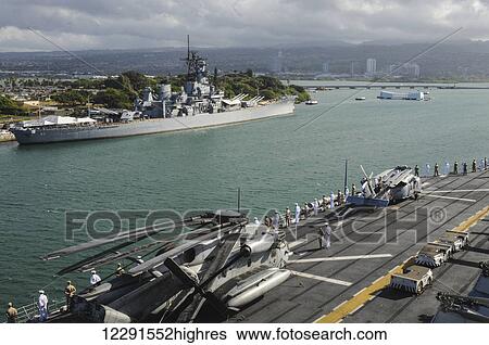 Stock Photograph - Sailors and Marines man the rails in dress uniform as a ship passes by the USS Missouri (BB-63) in Pearl Harbor; Oahu, Hawaii, United States of America. Fotosearch