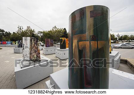 Stock Photograph - Scale models of the Maiden Tower painted by various artists by the Maiden Tower; Baku, Azerbaijan. Fotosearch