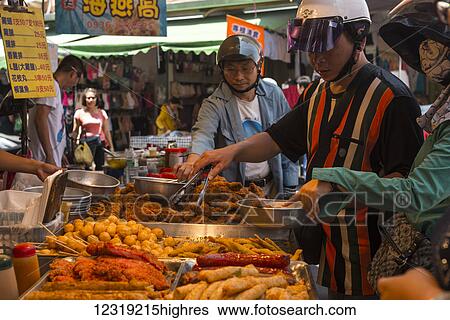 Scene from Luodong township in Yilan County, some locals just got down from their scooters and they are buying snacks in the market; Taiwan, China View Large Photo Image Stock Photograph - Scene from Luodong township in Yilan County, some locals just got down from their scooters and they are buying snacks in the market; Taiwan, China. Fotosearch