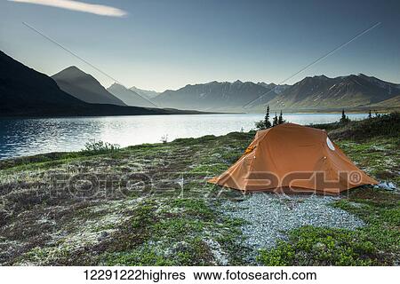 Scenic view of Lower Twin Lake with a backpacking tent in the foreground, Lake Clark National Park & Preserve, Southcentral Alaska View Large Photo Image Stock Photograph - Scenic view of Lower Twin Lake with a backpacking tent in the foreground, Lake Clark National Park & Preserve, Southcentral Alaska. Fotosearch