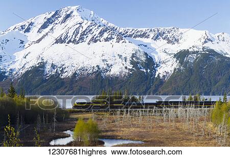 Scenic view of snow capped mountains near Bird Point as the Alaska Railroad passenger train passes by, Southcentral Alaska, USA View Large Photo Image Stock Photograph - Scenic view of snow capped mountains near Bird Point as the Alaska Railroad passenger train passes by, Southcentral Alaska, USA. Fotosearch