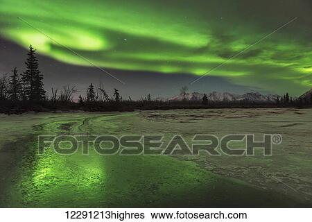 Scenic view of the aurora borealis over the frozen Knik River, Southcentral Alaska View Large Photo Image Stock Photograph - Scenic view of the aurora borealis over the frozen Knik River, Southcentral Alaska. Fotosearch