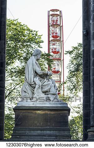 Stock Photograph - Scott Monument and a ferris wheel, Princes Street Gardens; Edinburgh, Scotland. Fotosearch