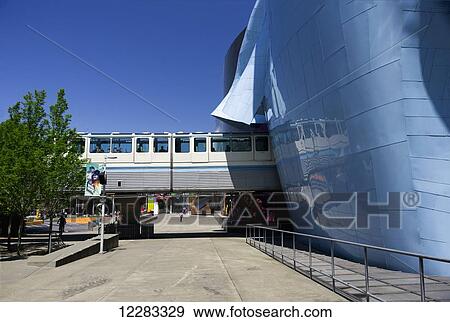 Seattle Center Monorail Skytrain comes out of EMP Museum heading for the Space Needle at Seattle Centre; Seattle, Washington, United States of America View Large Photo Image Stock Photo - Seattle Center Monorail Skytrain comes out of EMP Museum heading for the Space Needle at Seattle Centre; Seattle, Washington, United States of America. Fotosearch