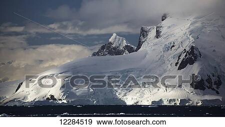 Stock Photo - Setting sun on Lemaire Island in Paradise Harbour, Antarctic Peninsula; Antarctica. Fotosearch