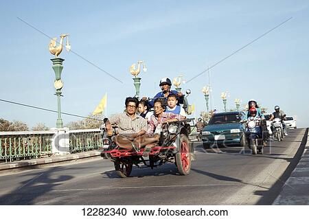 Several people on a scooter crossing a bridge; Chiang Mai, Thailand View Large Photo Image Stock Image - Several people on a scooter crossing a bridge; Chiang Mai, Thailand. Fotosearch