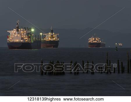 Stock Photograph - Ships anchor on the Columbia River at dusk near Astoria; Oregon, United States of America. Fotosearch