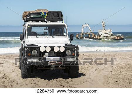 Shipwreck Zeila off the coast with a Land Rover Defender 110 parked on the beach in front of it, Henties Bay; Namibia View Large Photo Image Stock Image - Shipwreck Zeila off the coast with a Land Rover Defender 110 parked on the beach in front of it, Henties Bay; Namibia. Fotosearch