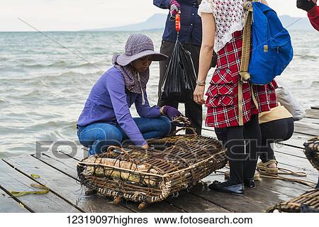 Stock Photograph - Shopping for fresh crab at the famous crab market; Kep, Cambodia. Fotosearch