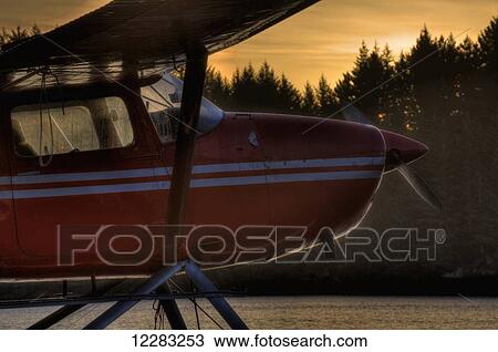 Stock Image - Side view of a seaplane at sunrise, Trident Basin Seaplane Base, Kodiak Island, Southwest Alaska, HDR. Fotosearch
