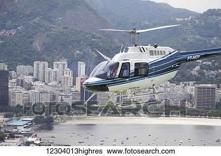 Sightseeing helicopter seen from Sugarloaf Mountain, looking to Botafogo Bay; Rio de Janeiro, Brazil View Large Photo Image Stock Photograph - Sightseeing helicopter seen from Sugarloaf Mountain, looking to Botafogo Bay; Rio de Janeiro, Brazil. Fotosearch