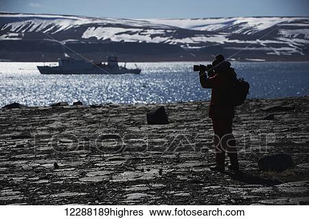 Silhouette of photographer shooting ship in fjord; Spitsbergen, Svalbard, Norway View Large Photo Image Stock Photograph - Silhouette of photographer shooting ship in fjord; Spitsbergen, Svalbard, Norway. Fotosearch