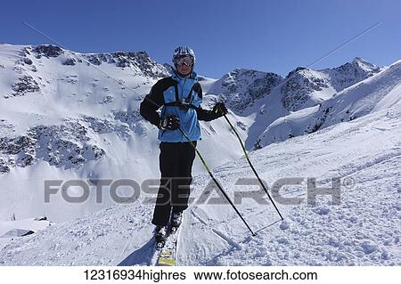 Stock Photograph - Skier against Blackcomb Gemstone Bowls; Whistler, British Columbia, Canada. Fotosearch