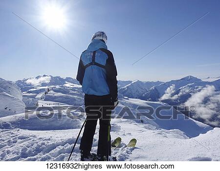 Stock Photograph - Skier at top of ski hill; Whistler, British Columbia, Canada. Fotosearch