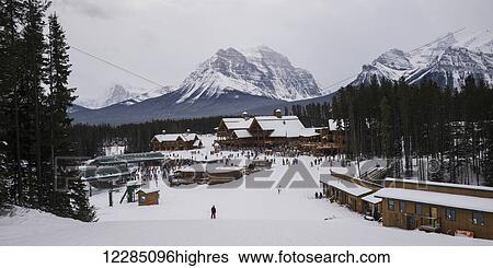 Stock Photograph - Skiers at a ski resort; Lake Louise, Alberta, Canada. Fotosearch