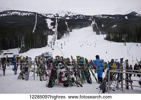 Stock Photograph - Skiers at a ski resort; Lake Louise, Alberta, Canada. Fotosearch